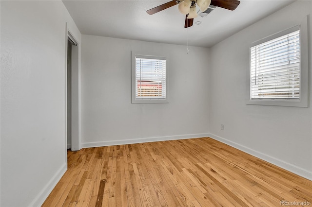 unfurnished room featuring light wood finished floors, baseboards, and ceiling fan