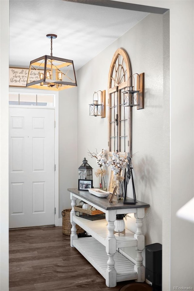 entrance foyer featuring dark hardwood / wood-style floors and a chandelier