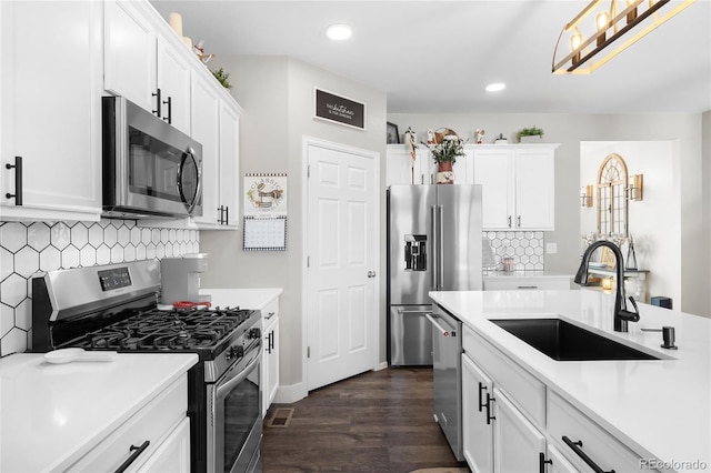 kitchen with sink, white cabinets, and appliances with stainless steel finishes