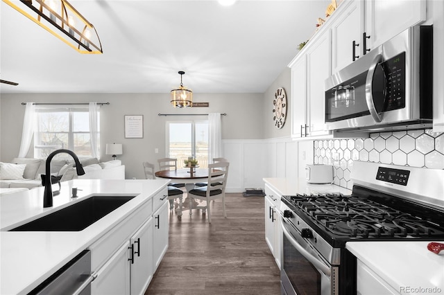 kitchen featuring white cabinetry, stainless steel appliances, sink, and a wealth of natural light