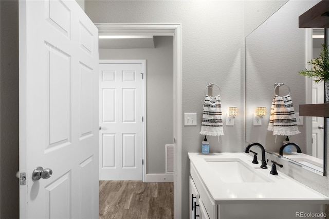 bathroom with vanity and hardwood / wood-style floors