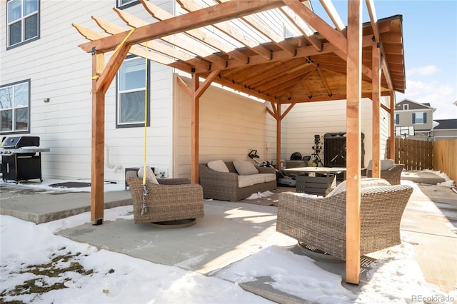 snow covered patio with grilling area, an outdoor hangout area, and a pergola