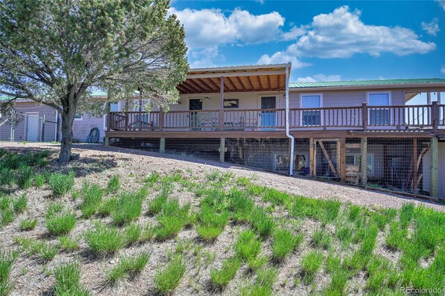 216 Rainbow Ridge Rd, Canon City, CO 81212 - back of property featuring a metal roof and a wooden deck