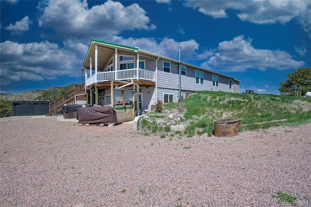 216 Rainbow Ridge Rd, Canon City, CO 81212 - back of property featuring a hot tub, a wooden deck, and stairs