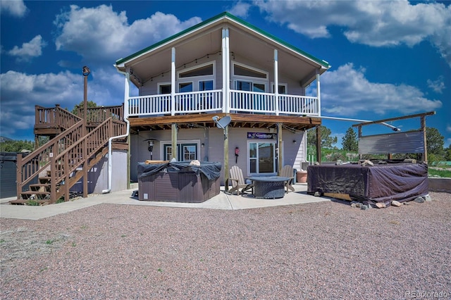 216 Rainbow Ridge Rd, Canon City, CO 81212 - rear view of house featuring a hot tub, a patio area, a deck, a fire pit, and stairs