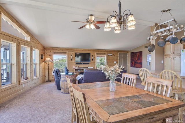 216 Rainbow Ridge Rd, Canon City, CO 81212 - dining space featuring wood walls, light carpet, a chandelier, and ceiling fan
