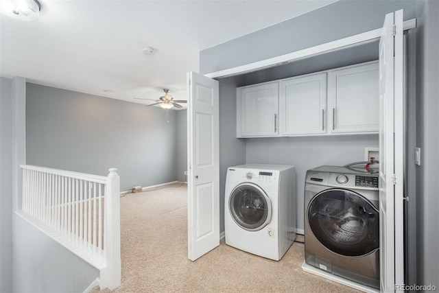 laundry area featuring cabinets, ceiling fan, light carpet, and independent washer and dryer