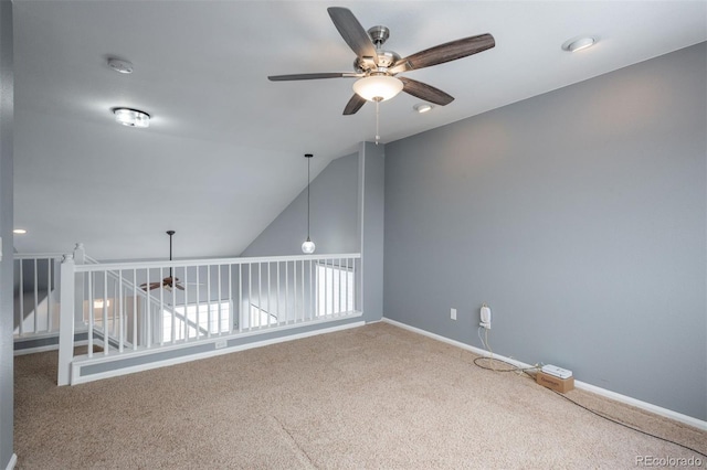 carpeted empty room featuring vaulted ceiling and ceiling fan