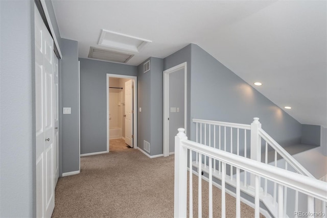 corridor featuring light colored carpet