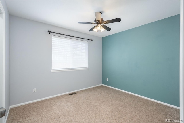 empty room with ceiling fan and carpet