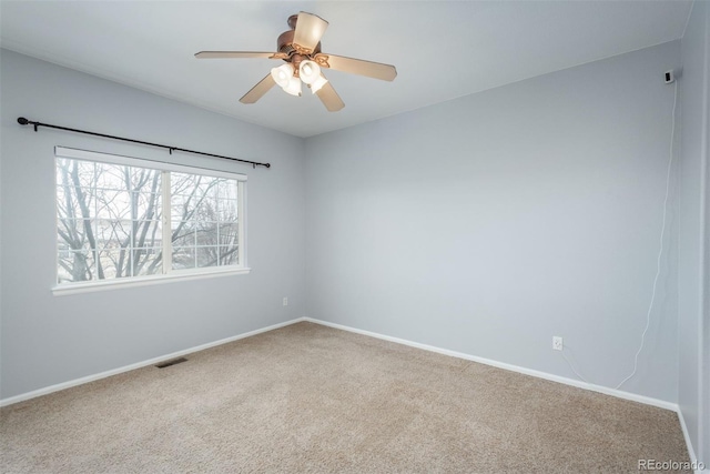 spare room featuring ceiling fan and carpet floors