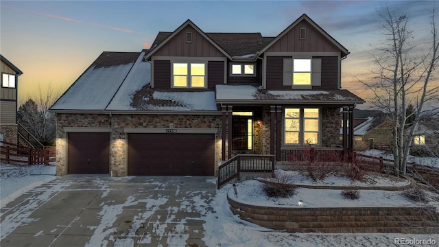 view of front of property featuring covered porch and a garage