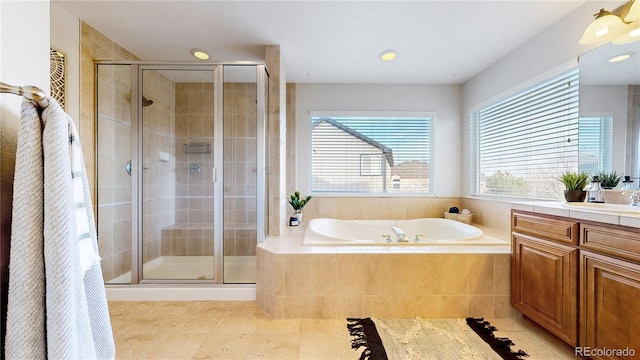 bathroom with tile patterned floors, vanity, and separate shower and tub