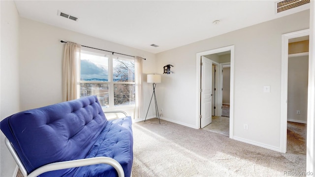 sitting room featuring light colored carpet