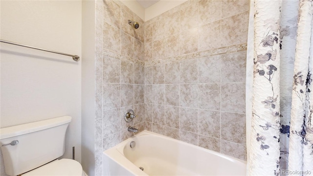 bathroom with shower / bath combo with shower curtain and toilet