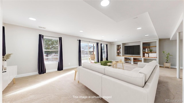 living room featuring built in features and light carpet