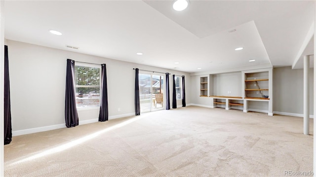 unfurnished living room with light colored carpet