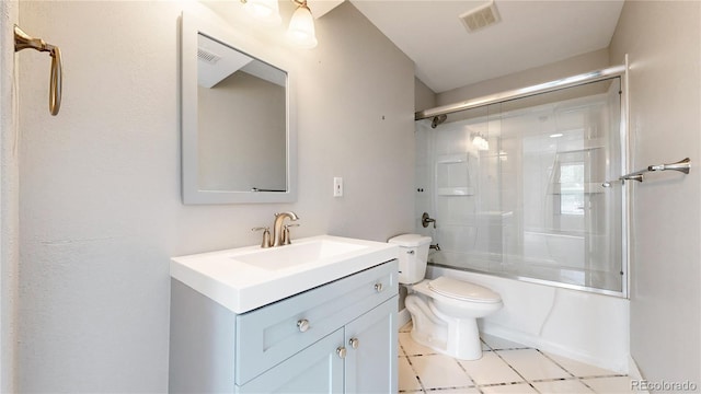 full bathroom featuring tile patterned floors, toilet, vanity, and combined bath / shower with glass door