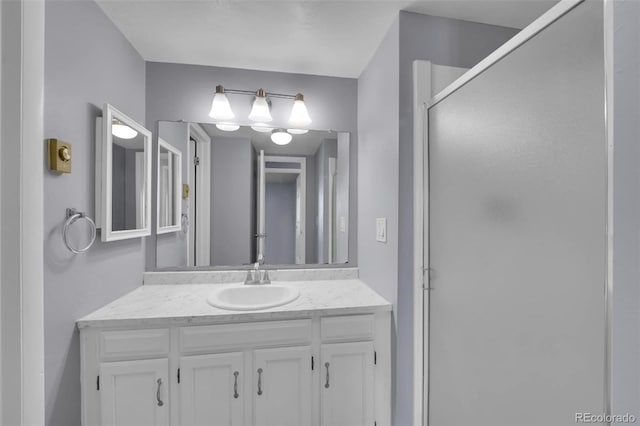 full bathroom featuring a shower stall and vanity