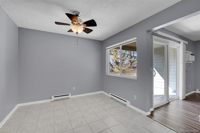 empty room featuring a baseboard heating unit, a textured ceiling, a ceiling fan, and baseboards