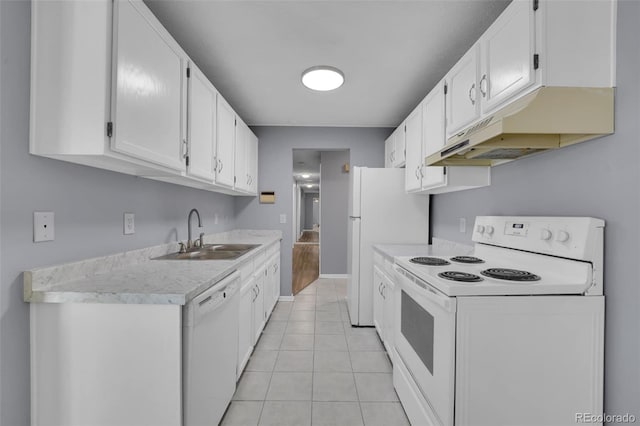 kitchen featuring white appliances, a sink, under cabinet range hood, light countertops, and white cabinetry
