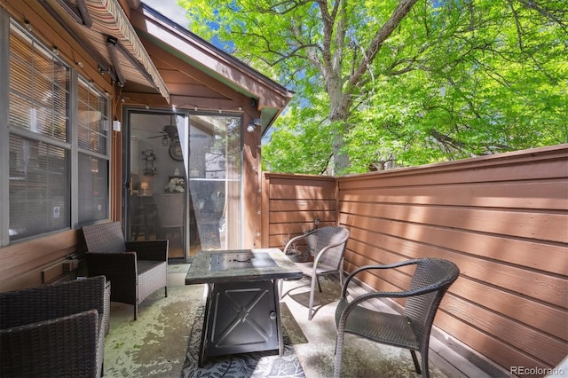 view of patio featuring a fire pit and fence