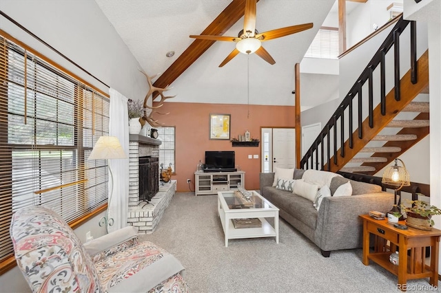 8010 Holland Ct Unit D, Arvada, CO 80005 - living room featuring carpet floors, beam ceiling, stairway, ceiling fan, and a brick fireplace
