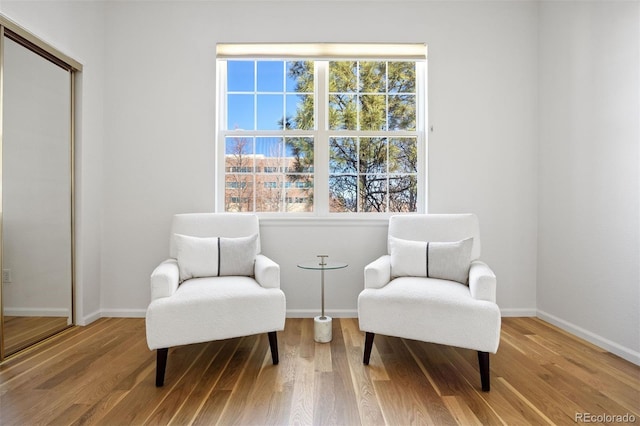 sitting room with baseboards and wood finished floors