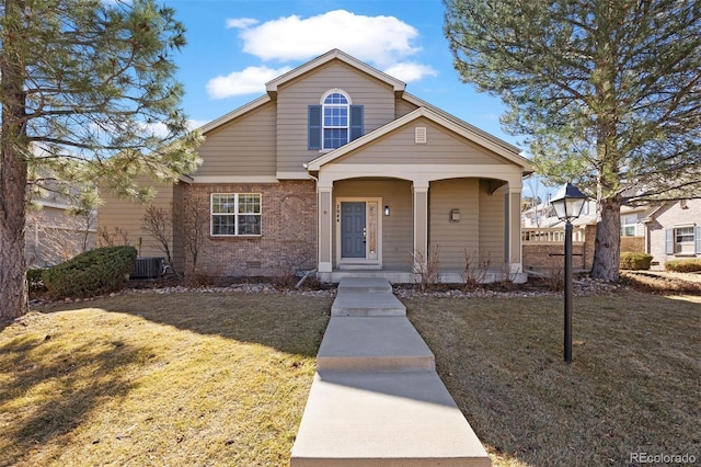 view of front of home featuring brick siding, covered porch, a front yard, crawl space, and central AC