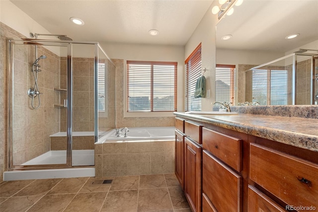 bathroom featuring tile patterned floors, vanity, and shower with separate bathtub