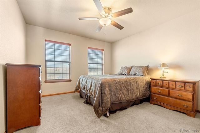 bedroom featuring light colored carpet and ceiling fan