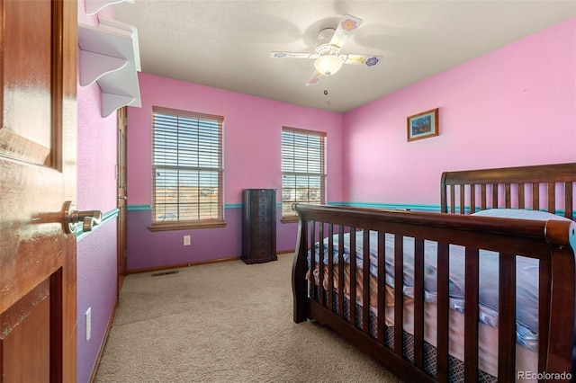 bedroom featuring light colored carpet and ceiling fan