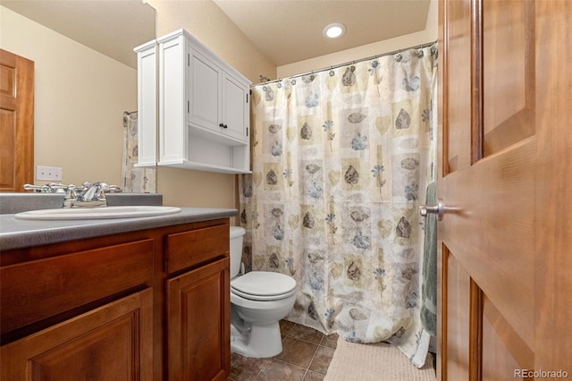 bathroom featuring vanity, toilet, and walk in shower