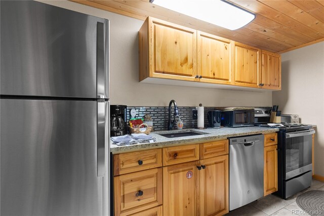 1400 David Dr Unit 1, Estes Park, CO 80517 - kitchen with light tile patterned flooring, appliances with stainless steel finishes, light stone counters, a sink, and wooden ceiling