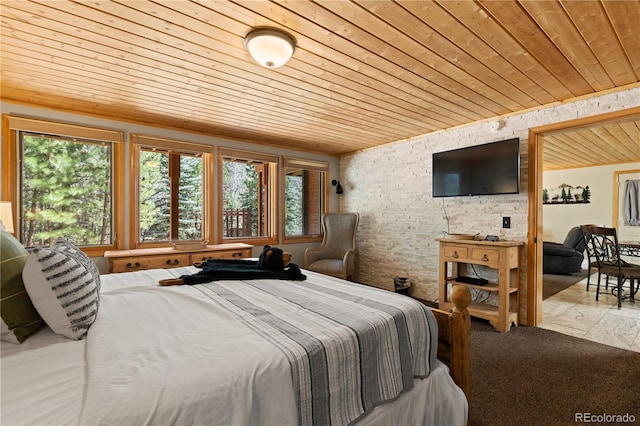 1400 David Dr Unit 1, Estes Park, CO 80517 - bedroom with wood ceiling, brick wall, and multiple windows