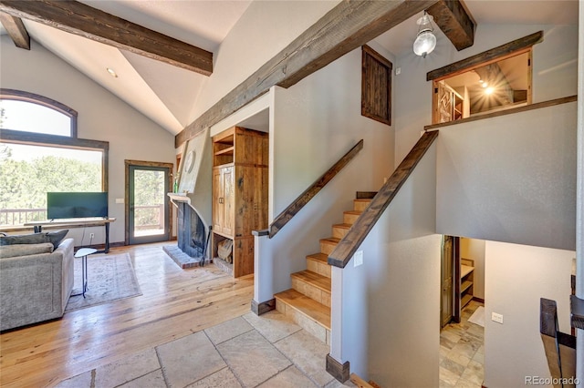 interior space featuring beamed ceiling, light hardwood / wood-style flooring, and high vaulted ceiling