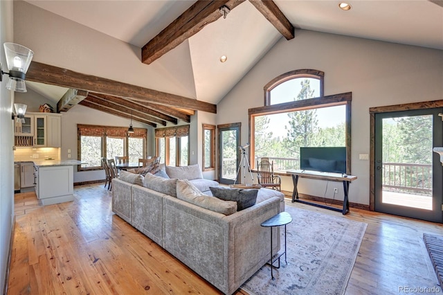 living room with beamed ceiling, high vaulted ceiling, and light wood-type flooring