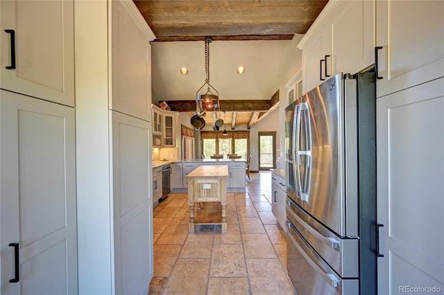 kitchen featuring light tile patterned floors, a kitchen island, stainless steel appliances, beamed ceiling, and hanging light fixtures