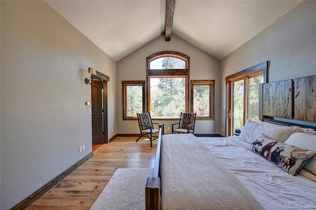 bedroom with light hardwood / wood-style floors, multiple windows, and lofted ceiling with beams