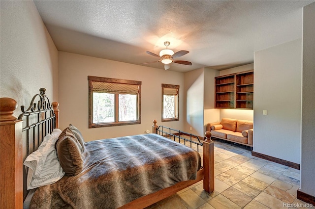 bedroom featuring a textured ceiling, ceiling fan, and light tile patterned floors