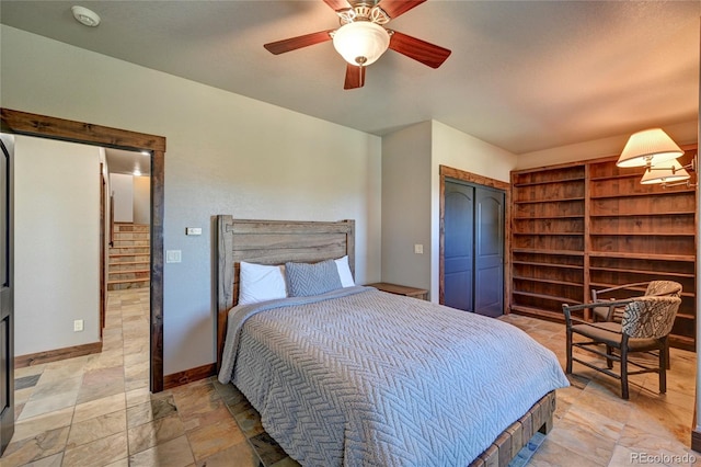 tiled bedroom with a closet and ceiling fan