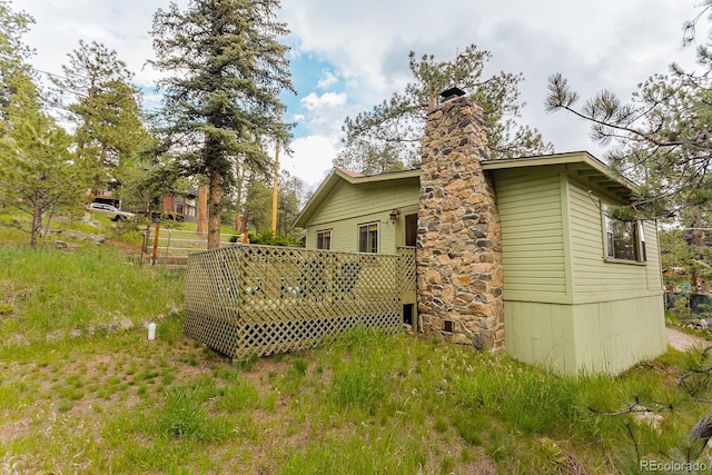 4850 Forest Hill Rd, Evergreen, CO 80439 - view of property exterior with a deck and a chimney