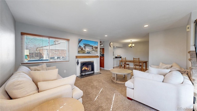 living room featuring a fireplace with flush hearth, recessed lighting, a chandelier, and carpet flooring