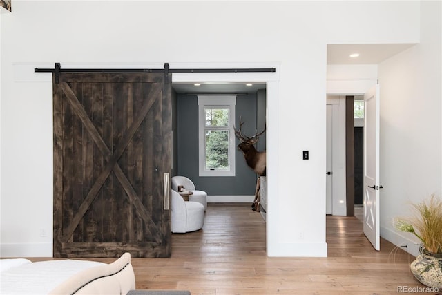 44 N Big Meadow Trl, Franktown, CO 80116 - bedroom with baseboards, light wood finished floors, recessed lighting, and a barn door