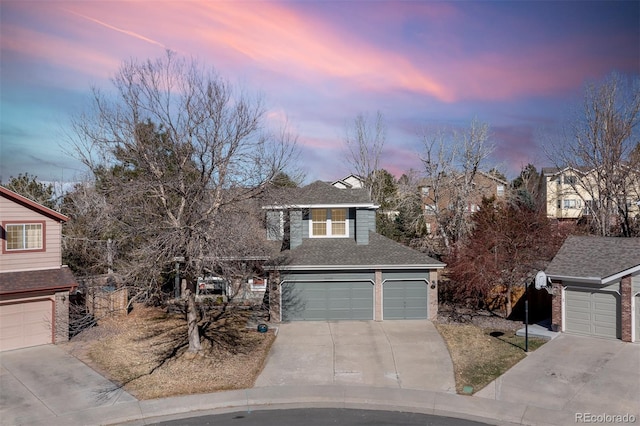 view of front of property featuring a garage, concrete driveway, roof with shingles, and brick siding