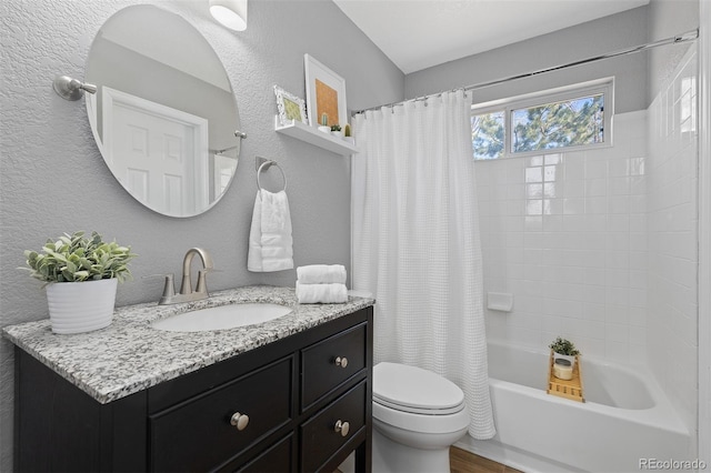 full bathroom with a textured wall, toilet, wood finished floors, vanity, and shower / bath combo with shower curtain