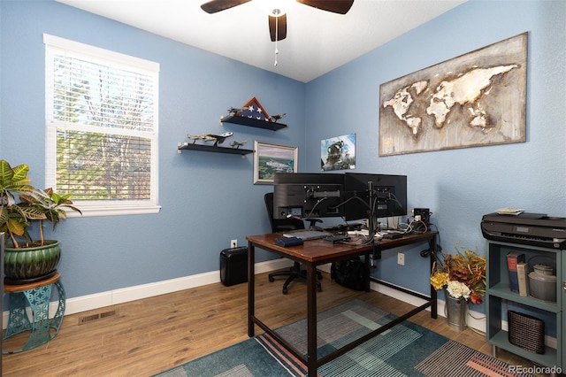 office with baseboards, visible vents, ceiling fan, and wood finished floors