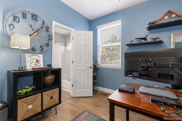 office space with visible vents, baseboards, and wood finished floors