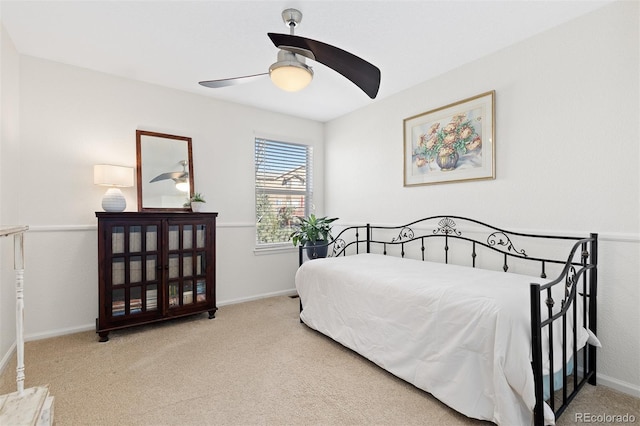 carpeted bedroom with a ceiling fan and baseboards