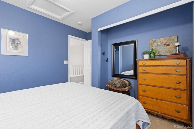 carpeted bedroom featuring attic access